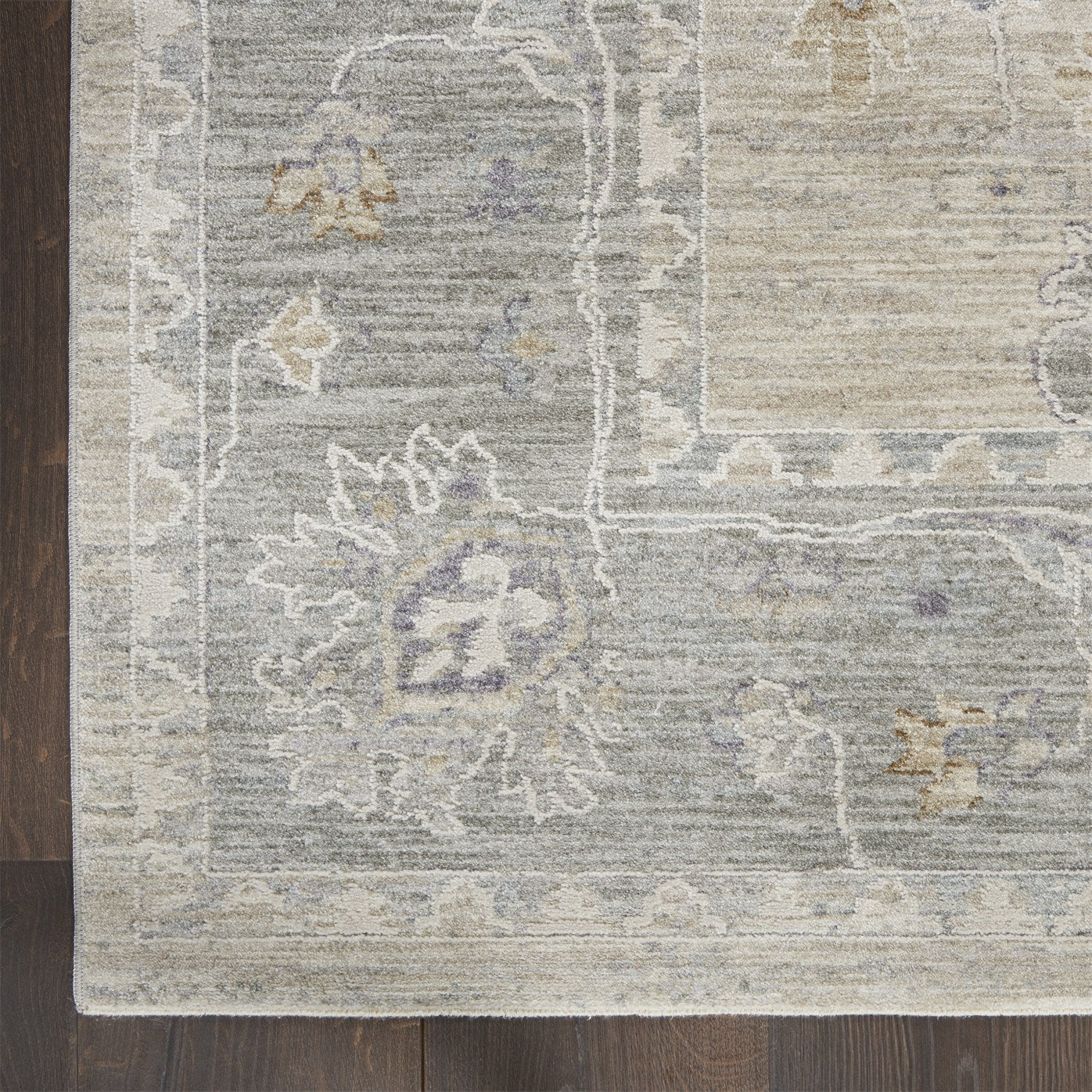 Close view of the corner of a wool rug lying flat against the floor