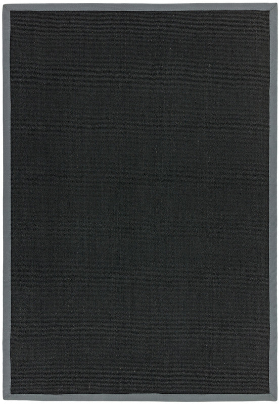 A grey flatweave sisal rug, the kind that needs an underlay on a hard floor