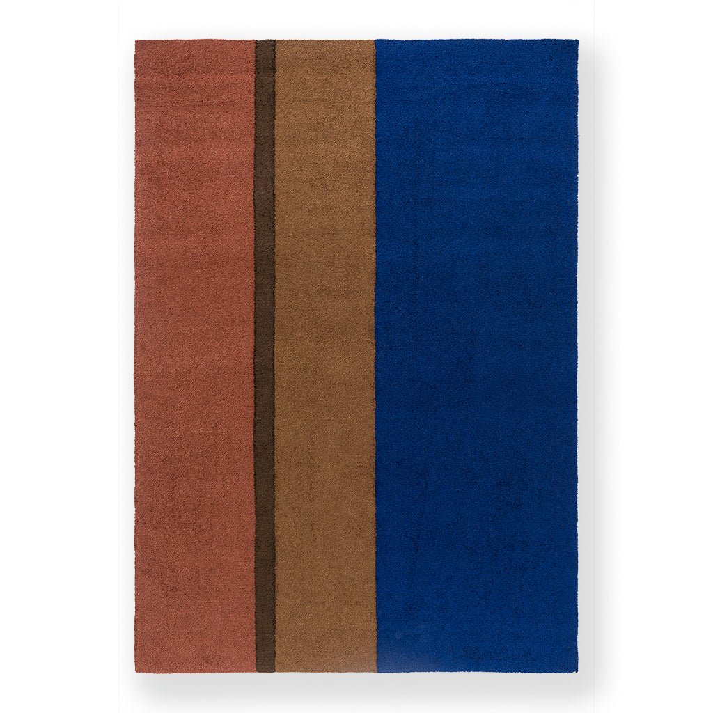 A blue striped indoor-outdoor rug in a hardwearing synthetic weave