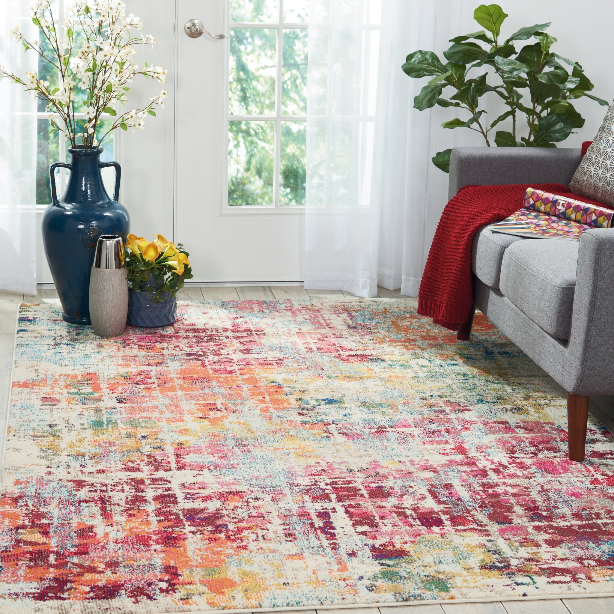 A pink multicoloured rug styled as the anchor of a scheme
