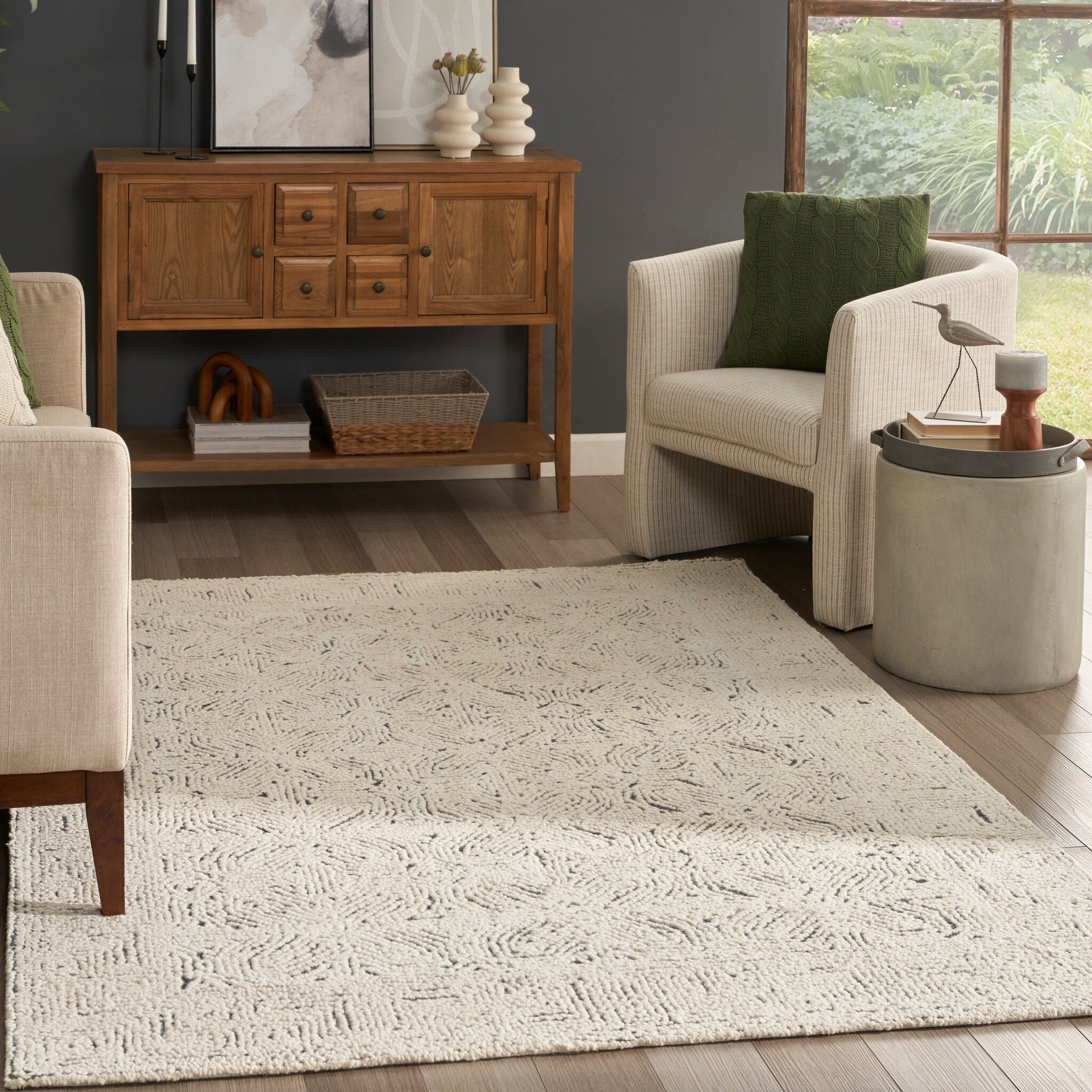 An ivory and navy rug used to define a seating area