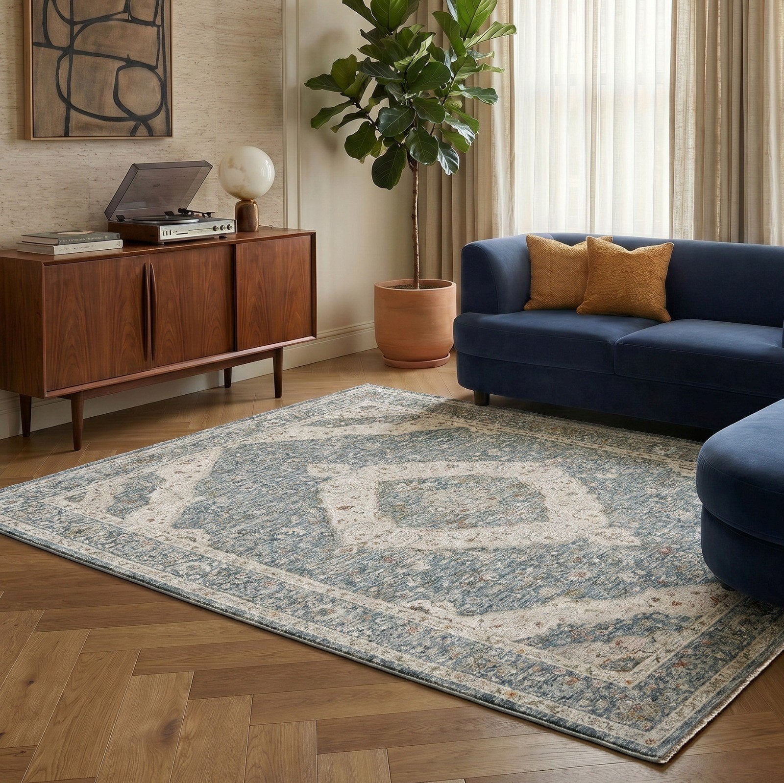 A light blue rug with a classic medallion design in a living room