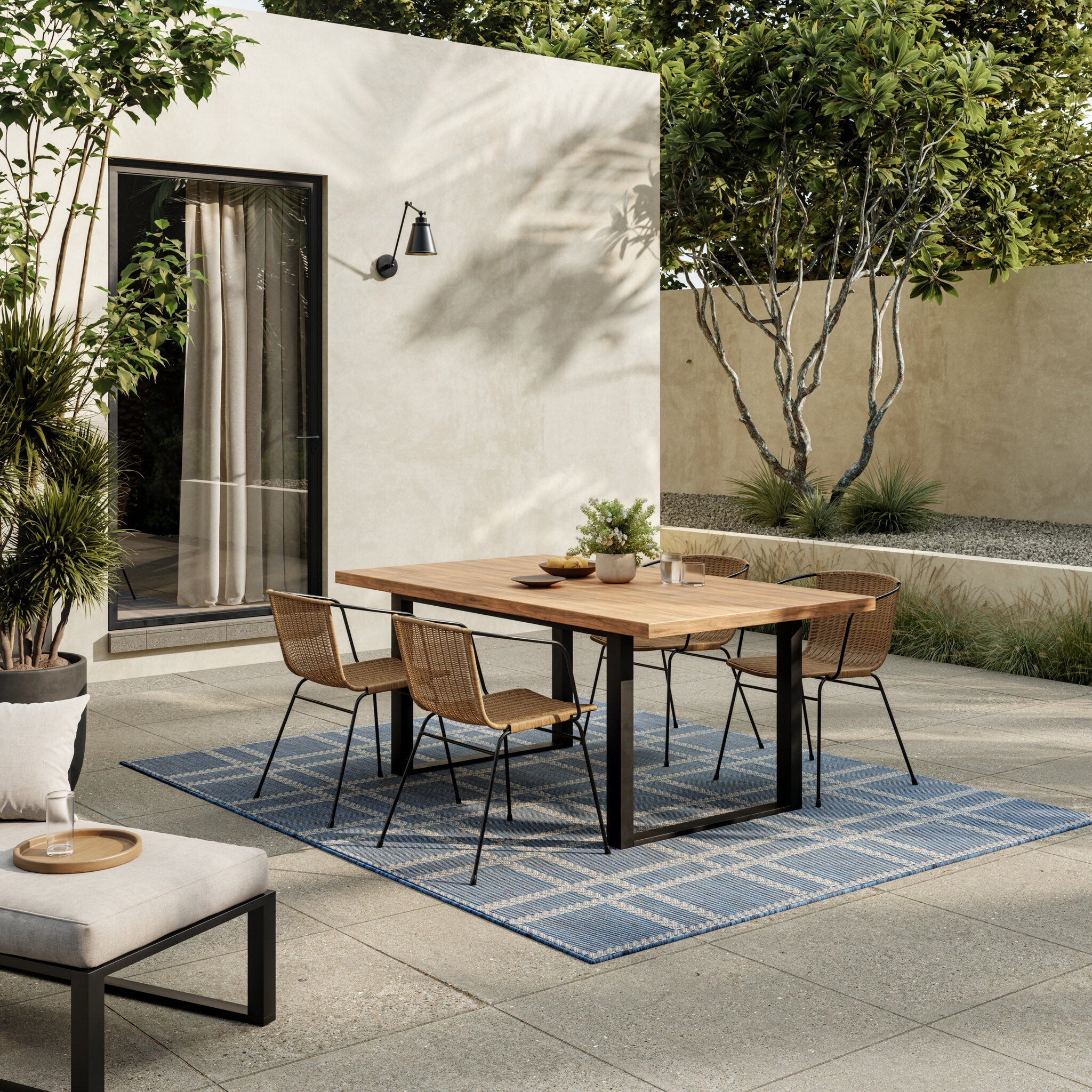 A navy indoor-outdoor rug of the kind suited to a conservatory or garden room