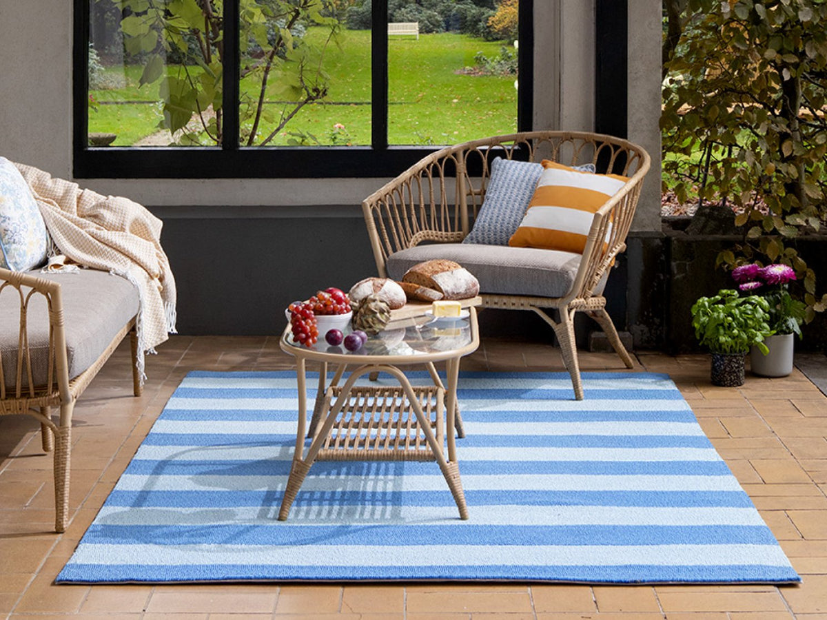 Laura Ashley Lille Sky Blue outdoor rug on a terrace