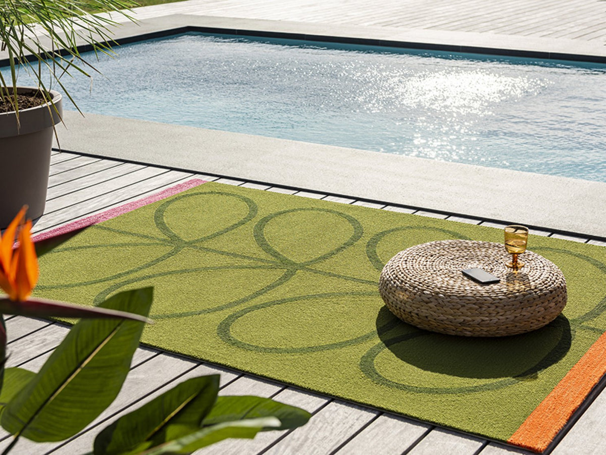 Orla Kiely Giant Linear Stem Seagrass outdoor rug on a terrace