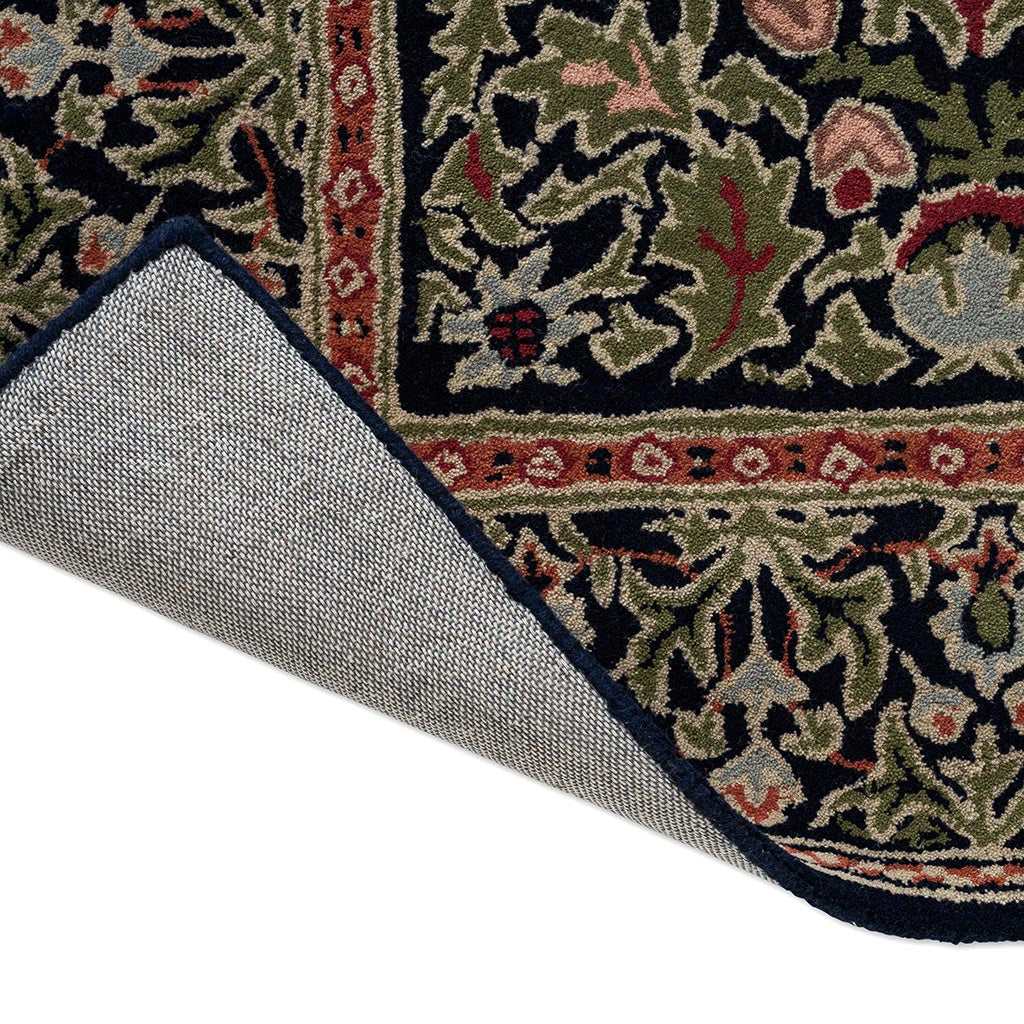 Morris & Co Wilton Weave Indigo rug corner turned to show the backing