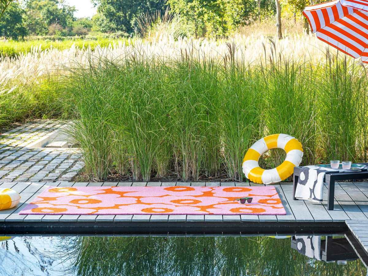 Marimekko Unikko Pink-Orange outdoor rug on a terrace
