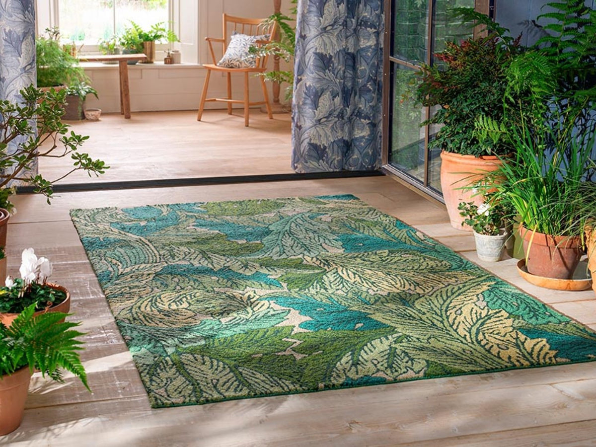 Morris & Co Acanthus Nettle Sky Blue outdoor rug on a terrace