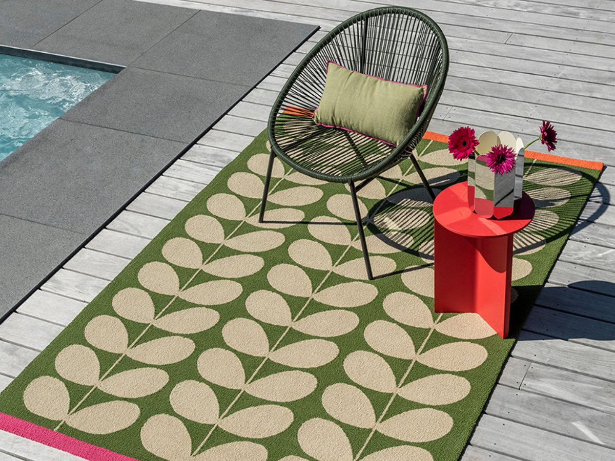Orla Kiely Solid Stem Basil outdoor rug on a terrace
