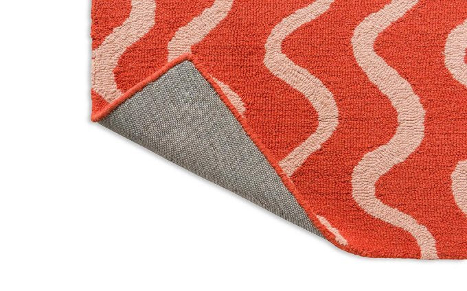 Scion Ribbon Coral rug corner turned to show the backing