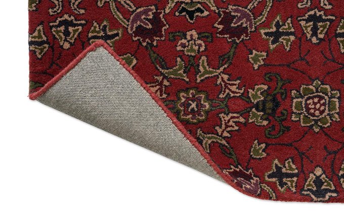 Morris & Co Persian Scroll Plum rug corner turned to show the backing