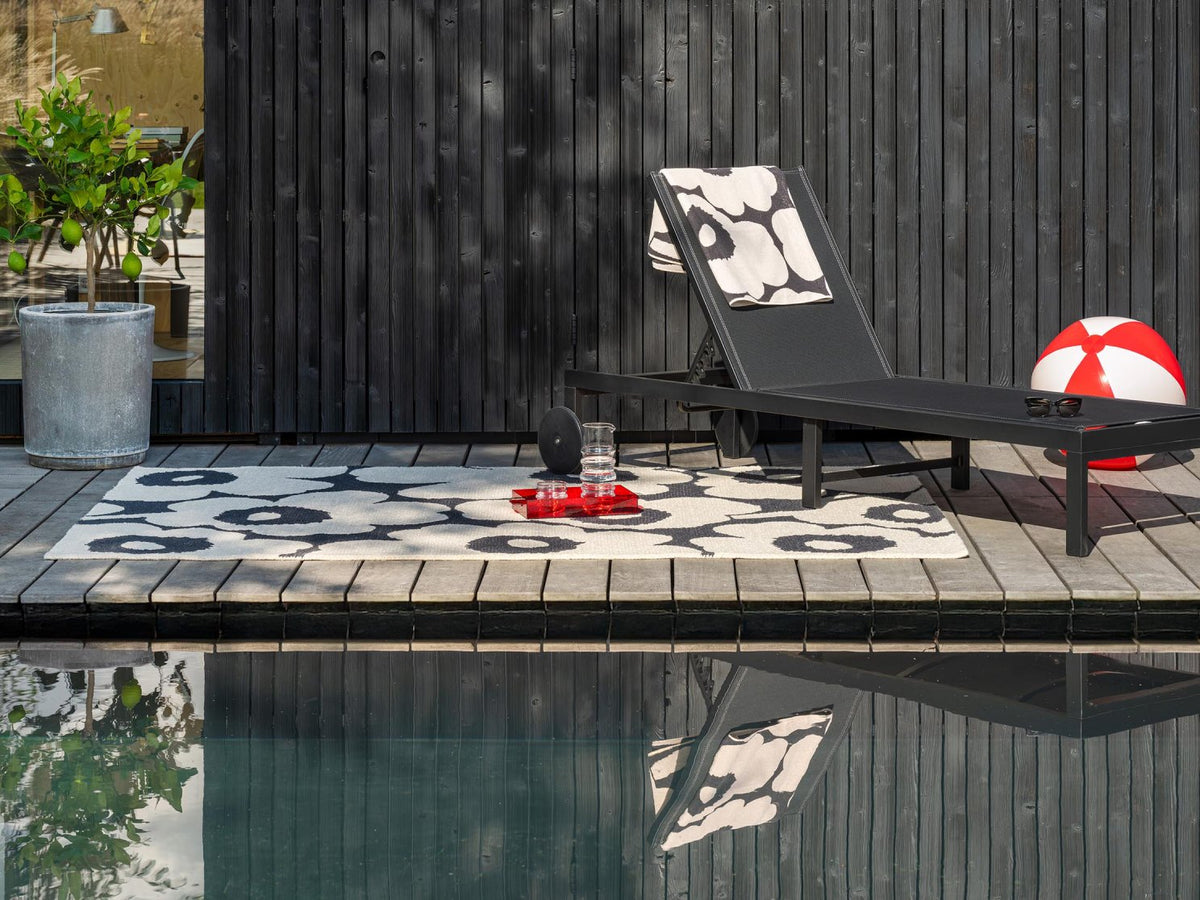 Marimekko Unikko Charcoal-White outdoor rug on a terrace