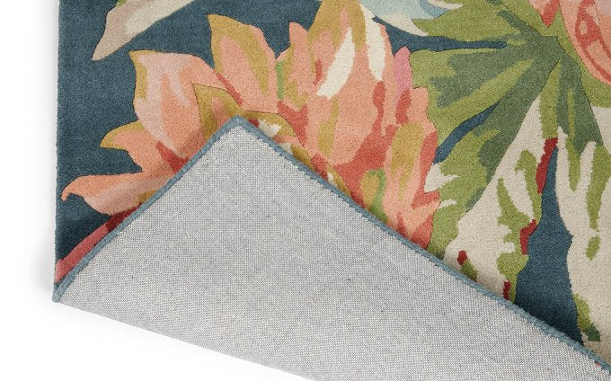 Sanderson Dahlia & Rosehip Teal 50608 rug corner turned to show the backing
