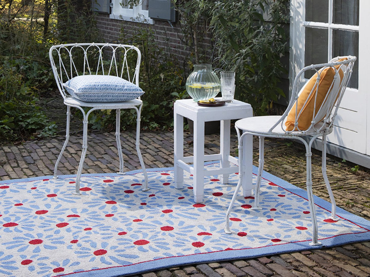 Laura Ashley Thorncliff Daisy Sky Blue outdoor rug on a terrace