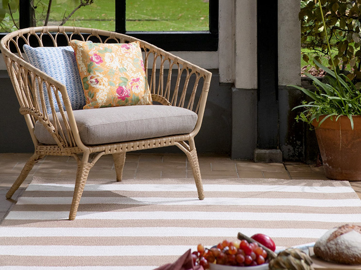 Laura Ashley Lille Pale Ochre outdoor rug on a terrace
