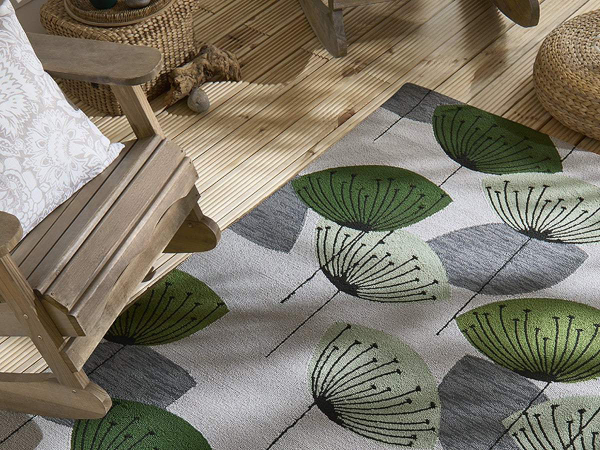 Sanderson Dandelion Clocks Botanical Green outdoor rug on a terrace