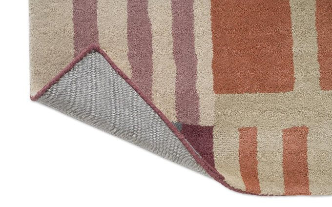 Harlequin Monolith Cinnabar/Amber 144200 rug corner turned to show the backing