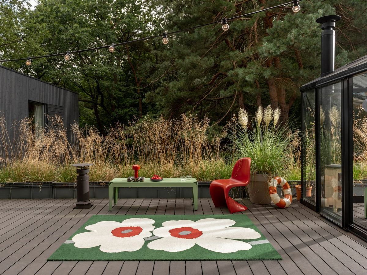 Marimekko Unikko Anniversary Green outdoor rug on a terrace