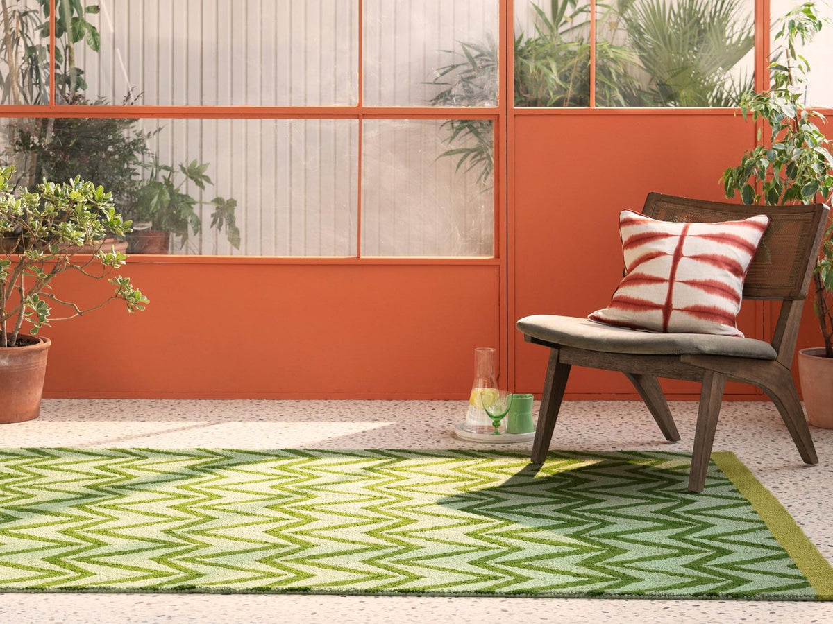 Scion Dhurrie Green outdoor rug on a terrace