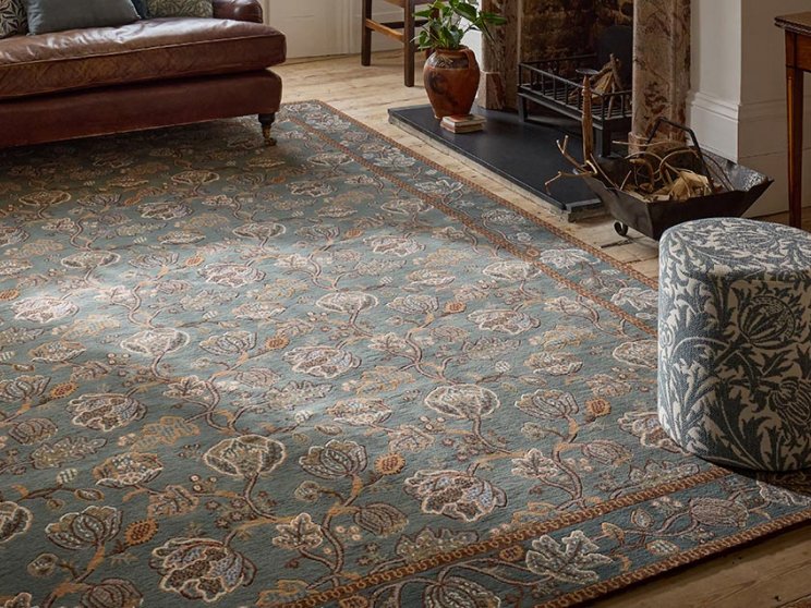 Morris & Co Theodosia Bottle Green hand-knotted rug styled in a room setting