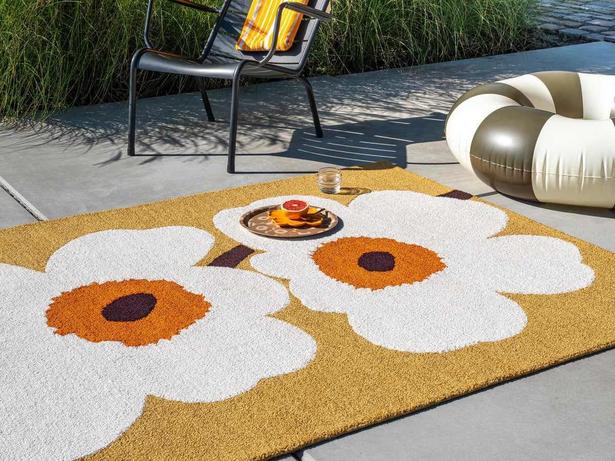 Marimekko Unikko Anniversary Honey outdoor rug on a terrace