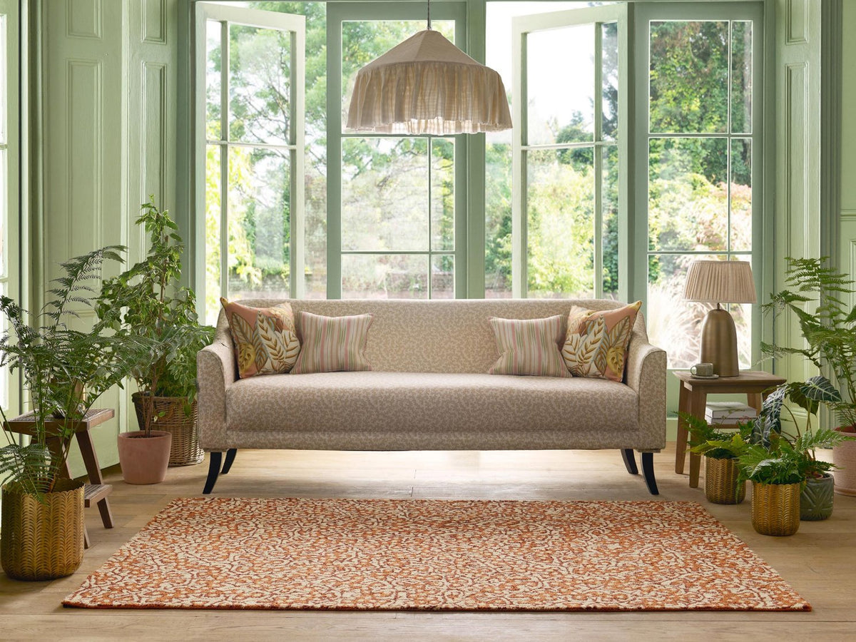 Sanderson Truffle Sandstone outdoor rug styled in a room setting