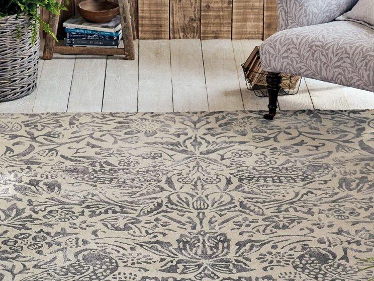 Morris & Co Pure Strawberry Thief Ink rug styled in a room setting