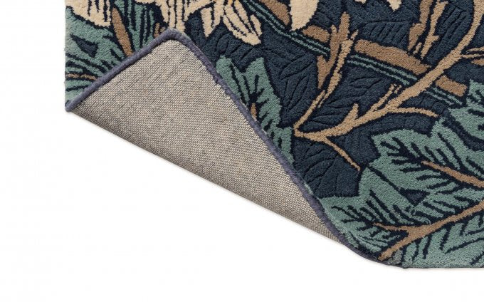 Morris & Co Honeysuckle & Tulip Woad Thyme rug corner turned to show the backing