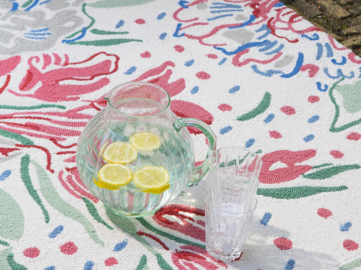 Laura Ashley Lilith Poppy Red outdoor rug on a terrace
