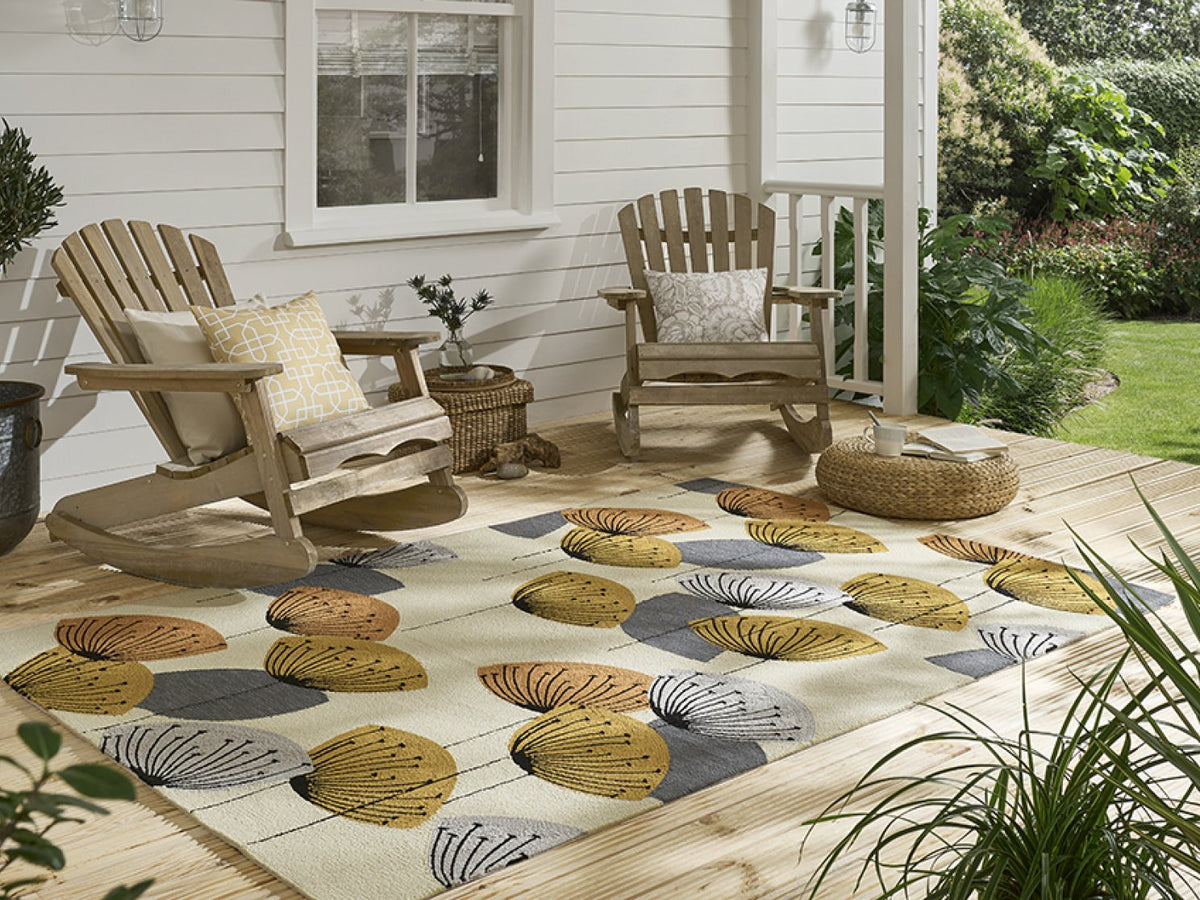 Sanderson Dandelion Clocks Ochre/Silver outdoor rug on a terrace