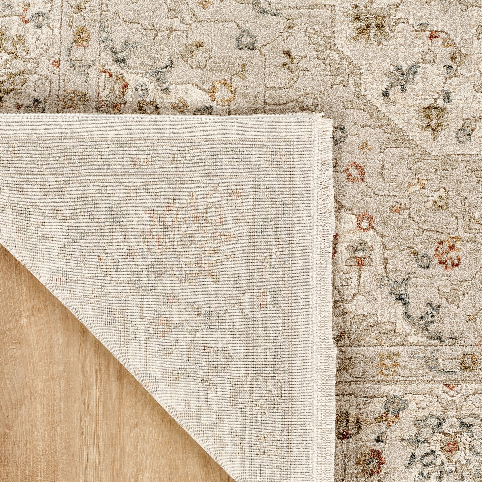 Comila Ivory rug corner folded showing backing