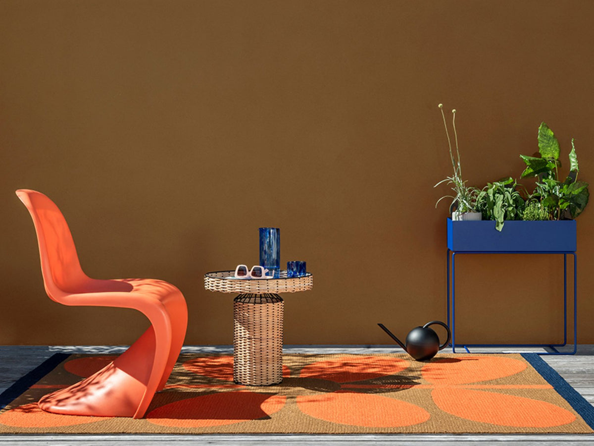 Orla Kiely Giant Sixties Stem Tomato outdoor rug on a terrace
