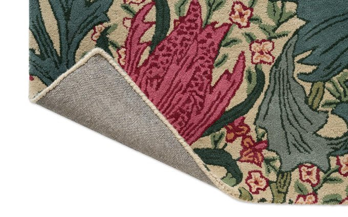 Morris & Co Lent Lily Plum Bayleaf rug corner turned to show the backing
