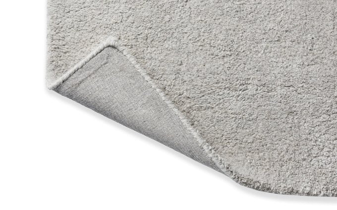 Decor Scape Natural Grey rug corner turned to show the backing