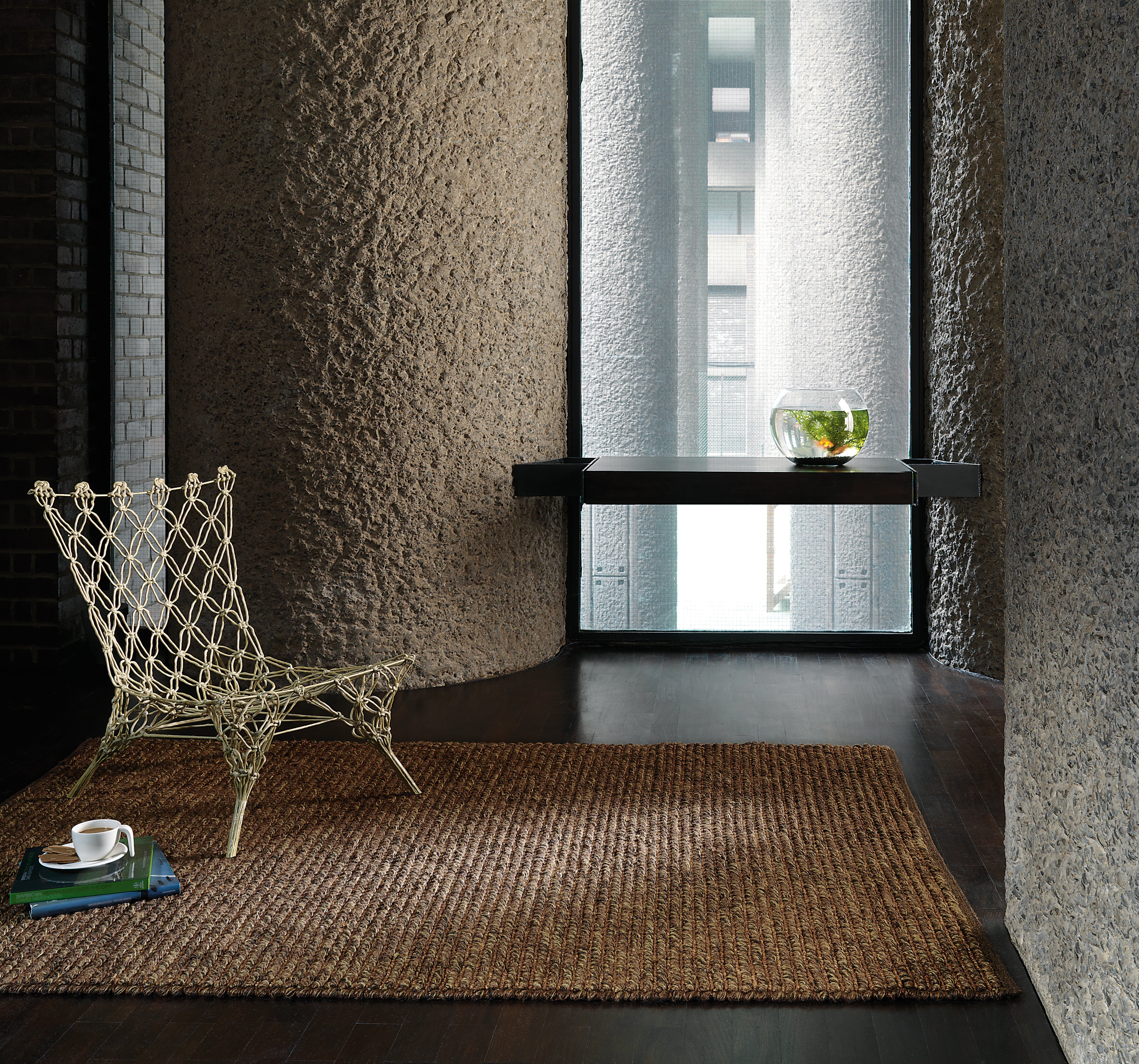 A brown jute rug showing the coarse natural loop weave