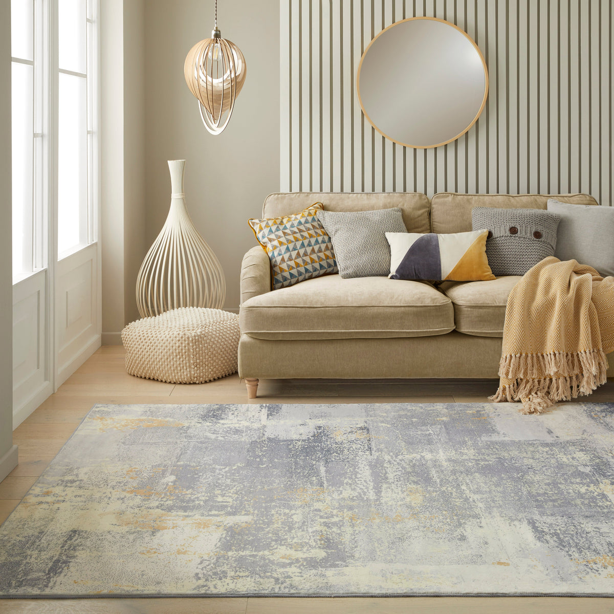 A light grey rug whose tone shifts with the light in a room