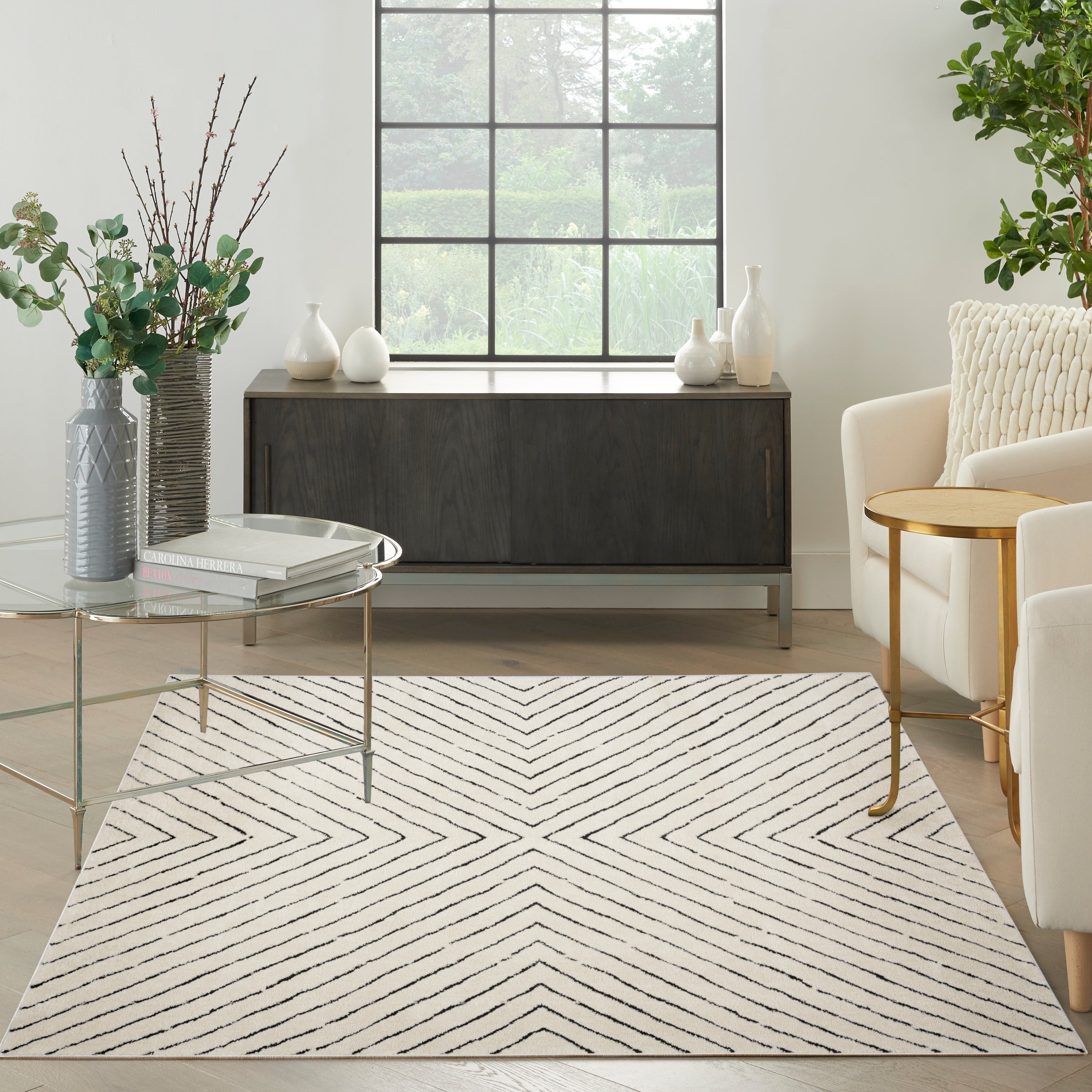 A large ivory and black rug defining a seating zone in an open space