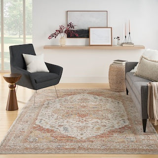 An ivory and rust traditional rug in a room setting