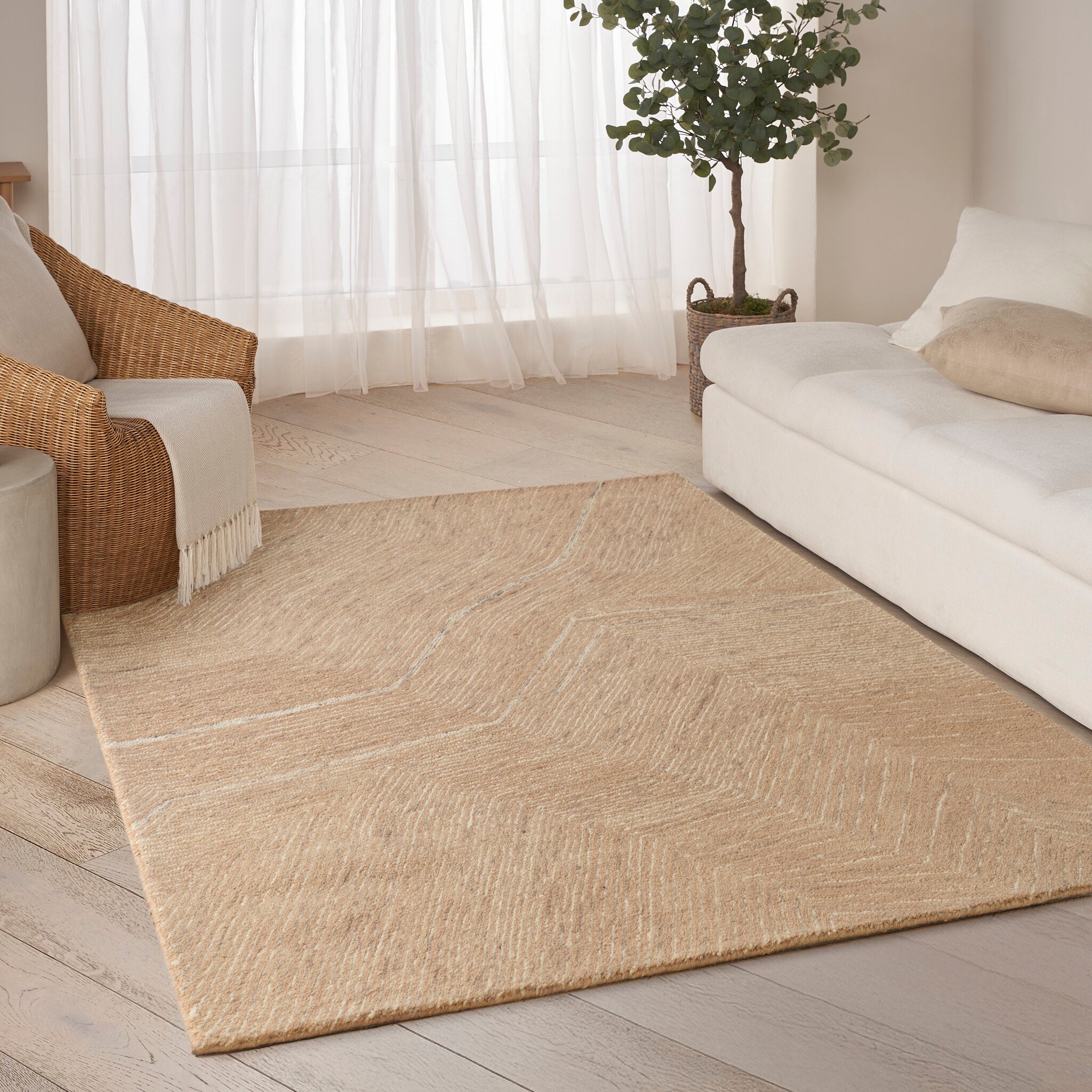 A camel-toned designer rug with a restrained geometric design