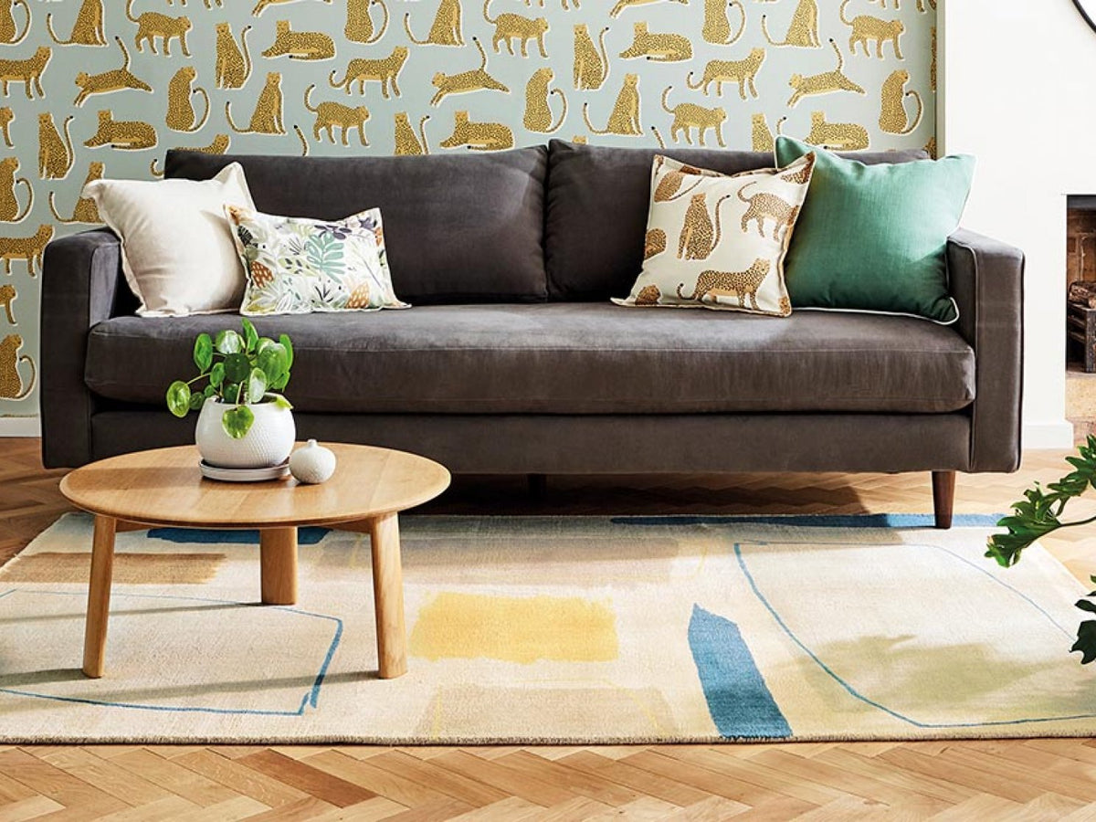 Scion Composition Papaya rug styled in a room setting