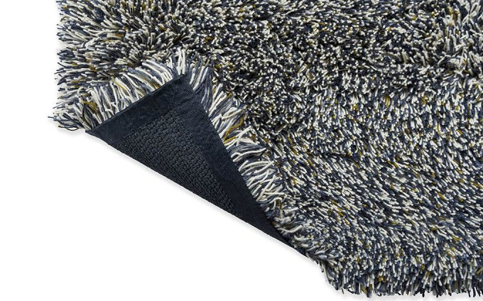 Jazz Plush Carbon rug corner turned to show the backing