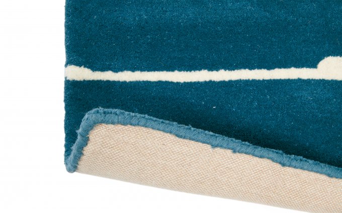 Scion Mr Fox Denim rug corner turned to show the backing