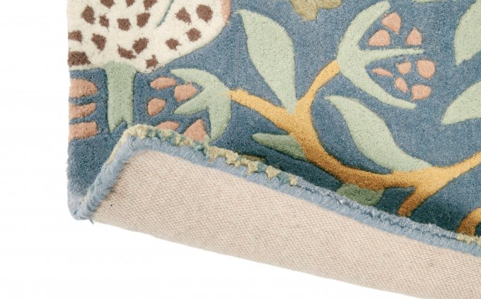 Morris & Co Strawberry Thief Slate rug corner turned to show the backing