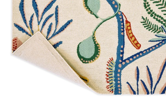 Scion Jackfruit and the Beanstalk Chai Sage rug corner turned to show the backing