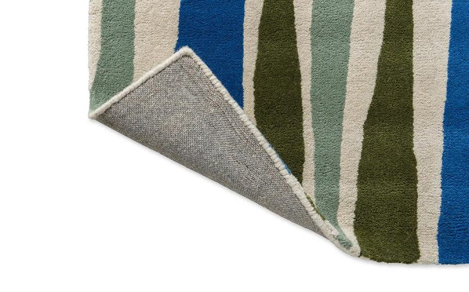Scion Saku Olive rug corner turned to show the backing