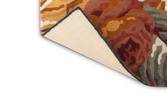 Sanderson Stapleton Park Navy/Burnt Orange 45318 rug corner turned to show the backing