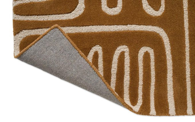 Harlequin Hollow Tan 141103 rug corner turned to show the backing