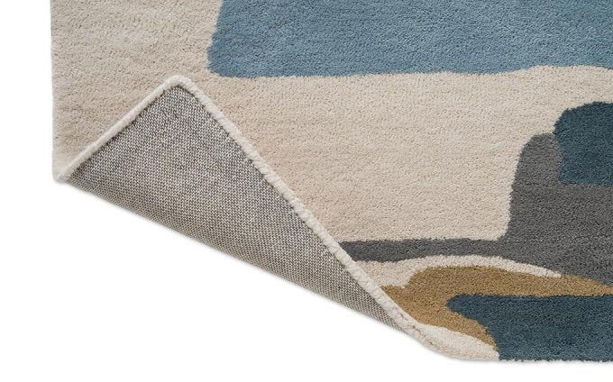 Harlequin Zeal Indigo 43008 rug corner turned to show the backing