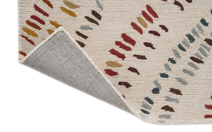 Harlequin Frescoes Amber 141701 rug corner turned to show the backing