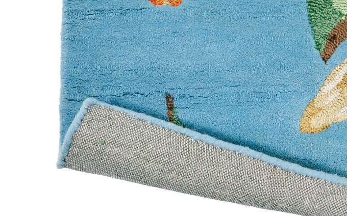 Wedgwood Hummingbird Blue 37808 rug corner turned to show the backing